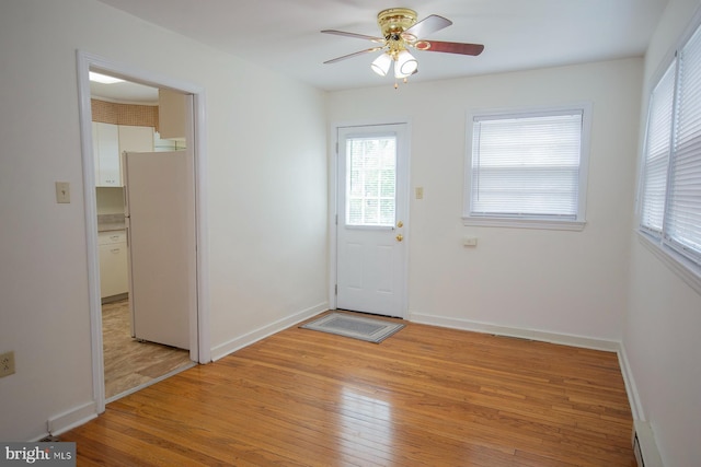 doorway to outside featuring light wood-type flooring and ceiling fan