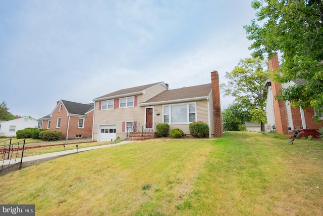 tri-level home featuring a front yard and a garage