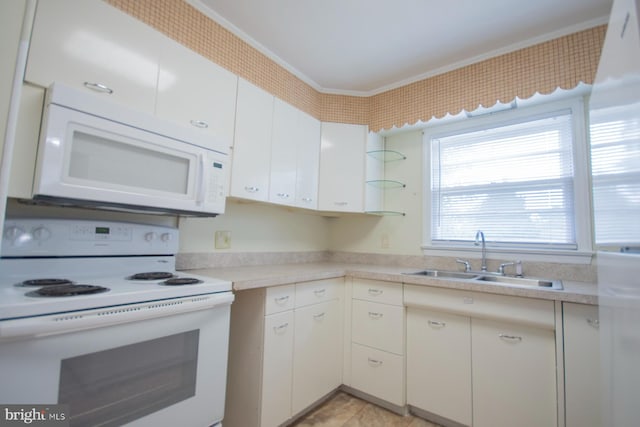 kitchen featuring white cabinets, sink, and white appliances