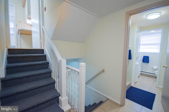 stairs featuring tile patterned flooring and a baseboard heating unit