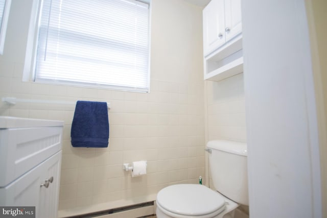 bathroom featuring toilet, tile walls, and a baseboard radiator