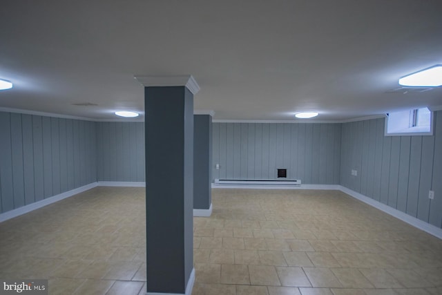 basement with baseboard heating, wood walls, and ornamental molding