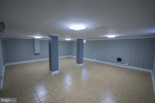 basement with a baseboard radiator, crown molding, and wood walls