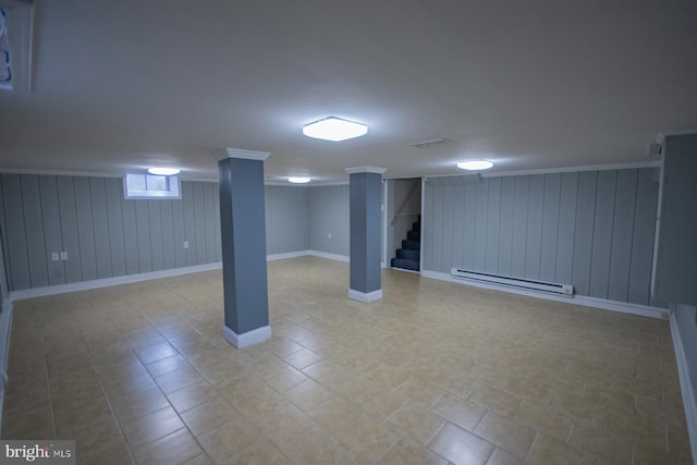 basement featuring baseboard heating and wooden walls