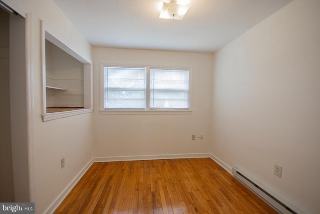 spare room featuring light hardwood / wood-style floors and a baseboard radiator