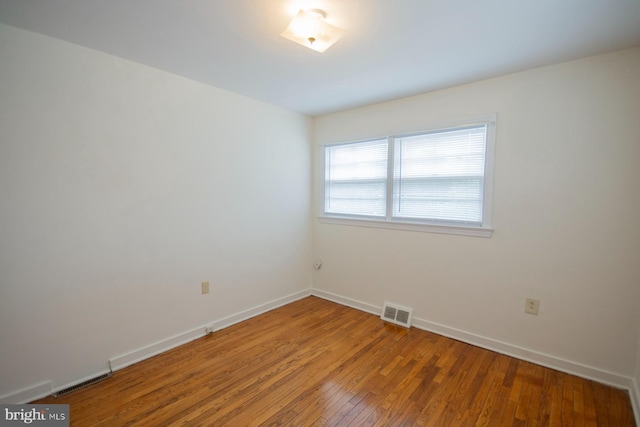 empty room featuring wood-type flooring