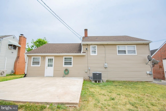 rear view of house with central AC, a patio area, and a yard