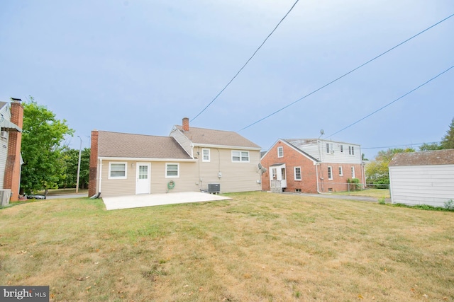 back of property featuring central AC, a yard, and a patio