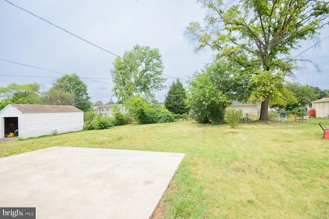 view of yard with an outbuilding and a patio area