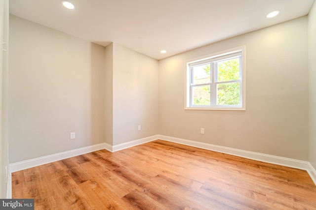 unfurnished room with hardwood / wood-style floors