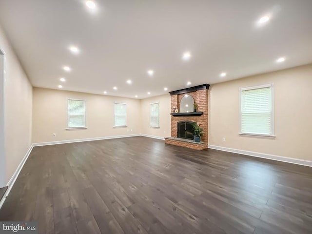 unfurnished living room featuring dark hardwood / wood-style floors and a fireplace