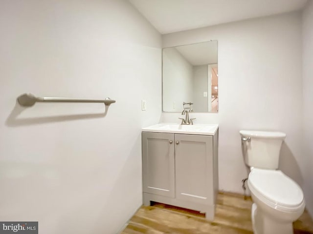 bathroom featuring hardwood / wood-style floors, toilet, and vanity