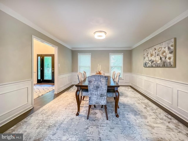 dining space with plenty of natural light, dark hardwood / wood-style flooring, and ornamental molding