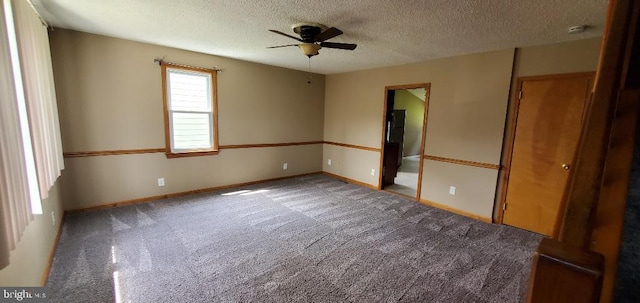 carpeted empty room with a textured ceiling and ceiling fan