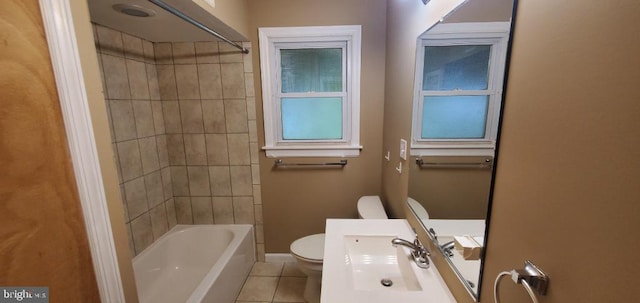 full bathroom with tiled shower / bath combo, toilet, tile patterned floors, and sink