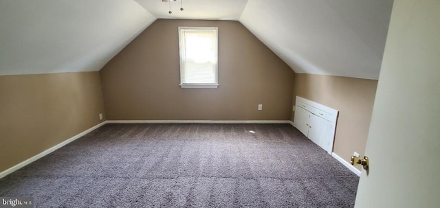 bonus room with carpet floors and vaulted ceiling