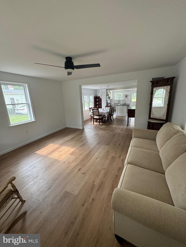 living room featuring ceiling fan and hardwood / wood-style flooring