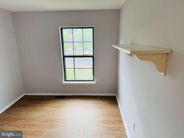 empty room with light hardwood / wood-style flooring