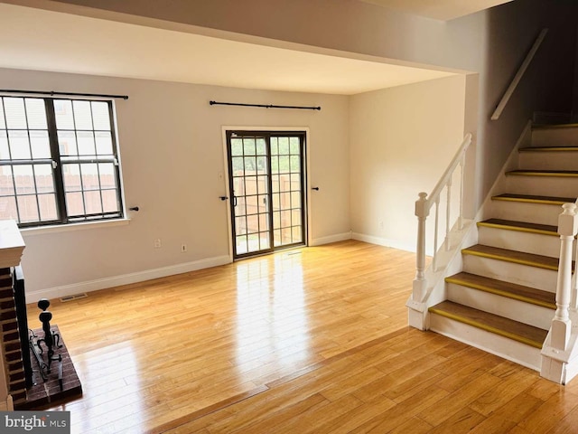 unfurnished living room with light hardwood / wood-style floors