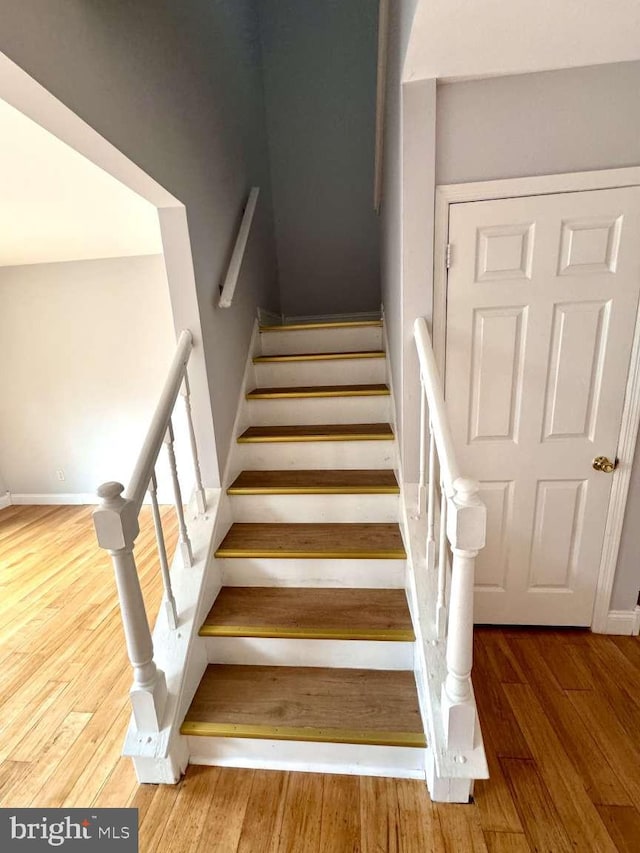 stairs featuring hardwood / wood-style flooring