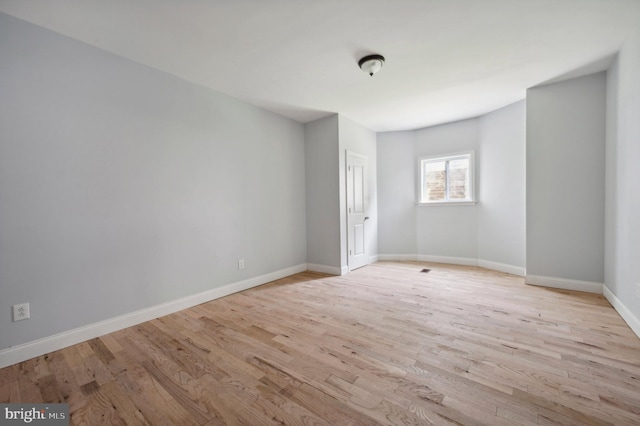 spare room featuring light hardwood / wood-style flooring