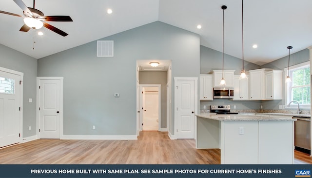 kitchen with hanging light fixtures, ceiling fan, light hardwood / wood-style flooring, and stainless steel appliances