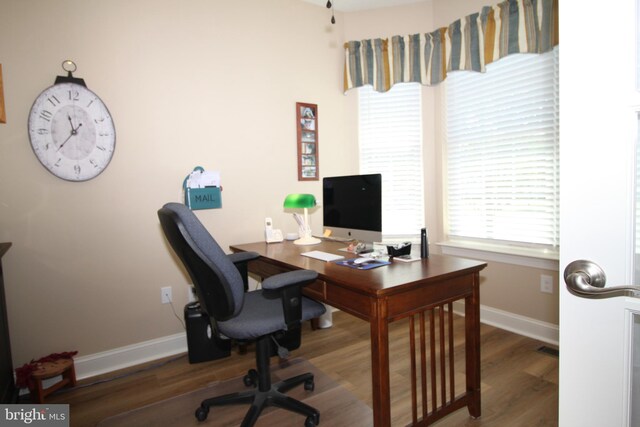 office space featuring baseboards and wood finished floors