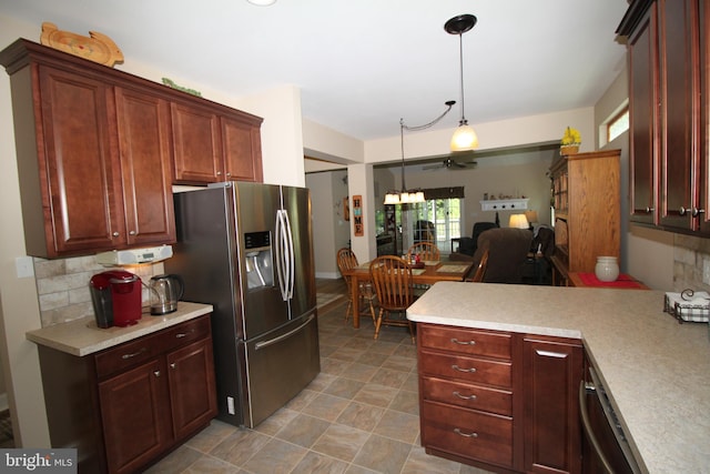 kitchen with pendant lighting, backsplash, kitchen peninsula, stainless steel appliances, and ceiling fan