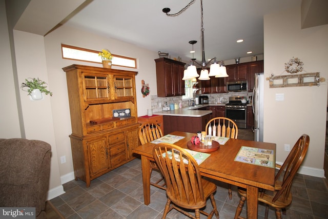 dining room featuring sink and a chandelier