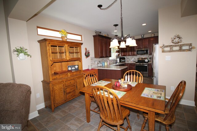 dining room with recessed lighting and baseboards