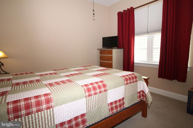 carpeted bedroom with baseboards