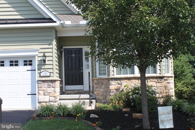 view of exterior entry with a garage