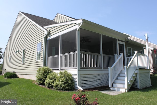 view of side of home featuring a yard and a sunroom