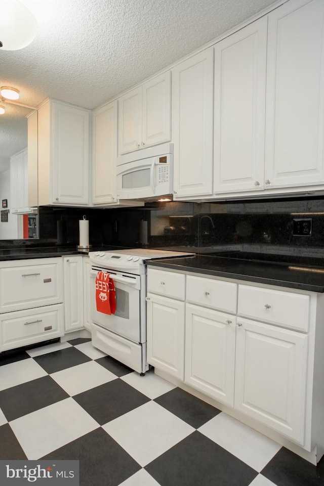 kitchen with a textured ceiling, white cabinets, and white appliances