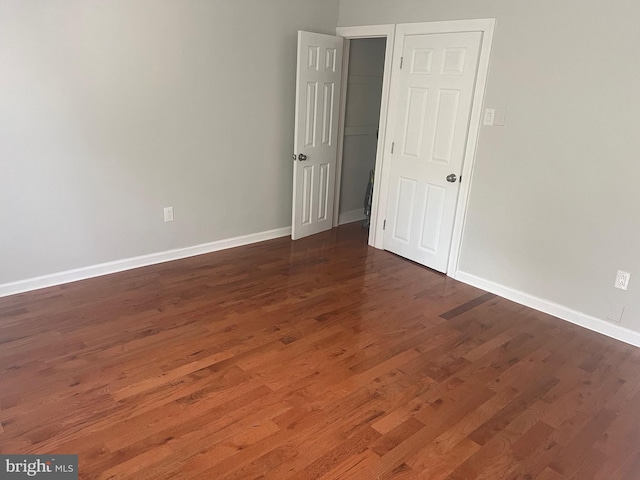 spare room with dark hardwood / wood-style floors