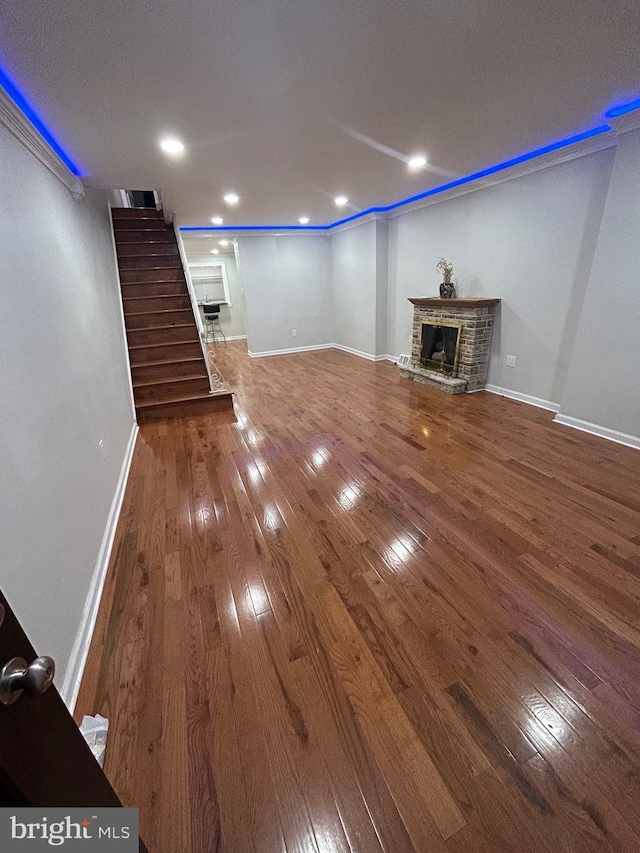 unfurnished living room with hardwood / wood-style flooring and a fireplace