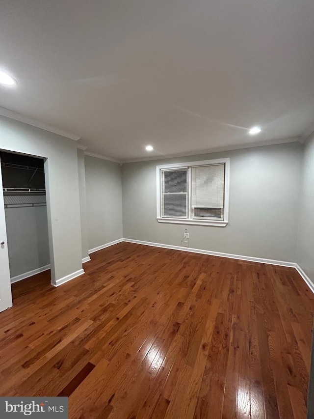 unfurnished bedroom with crown molding and wood-type flooring