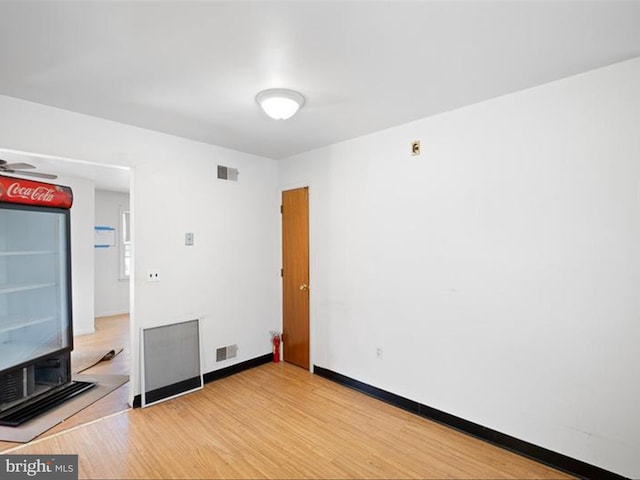 unfurnished room with hardwood / wood-style flooring