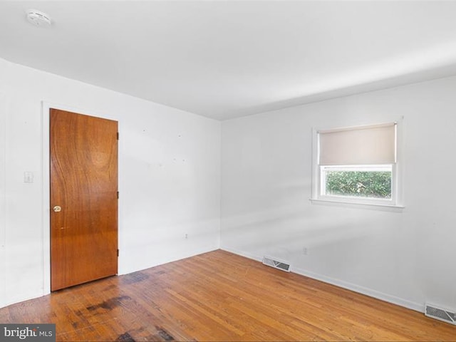 empty room with hardwood / wood-style flooring