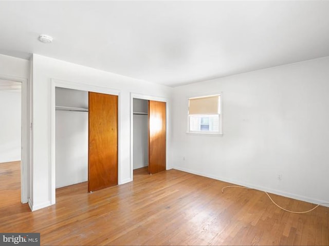 unfurnished bedroom with hardwood / wood-style floors