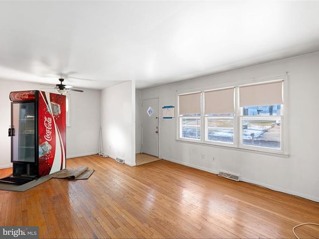 entrance foyer with ceiling fan and wood-type flooring