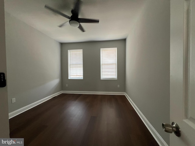 empty room featuring ceiling fan and dark hardwood / wood-style floors