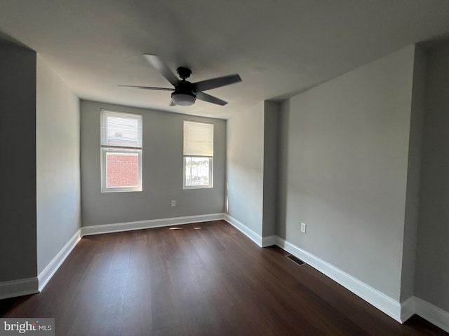 empty room featuring ceiling fan and dark hardwood / wood-style flooring