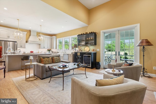 living room with wine cooler and light wood-type flooring