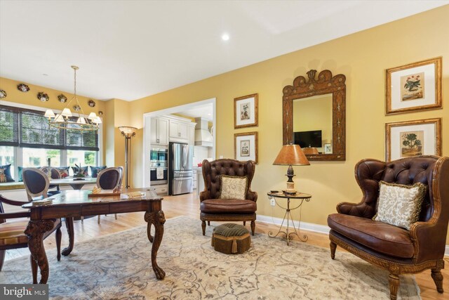 dining space featuring light hardwood / wood-style floors and a notable chandelier