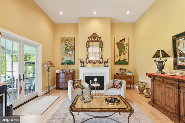 living room featuring light hardwood / wood-style floors and a high end fireplace