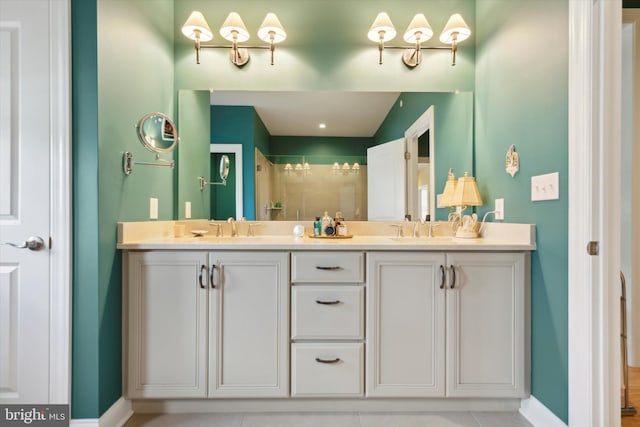 bathroom with double vanity and tile patterned floors