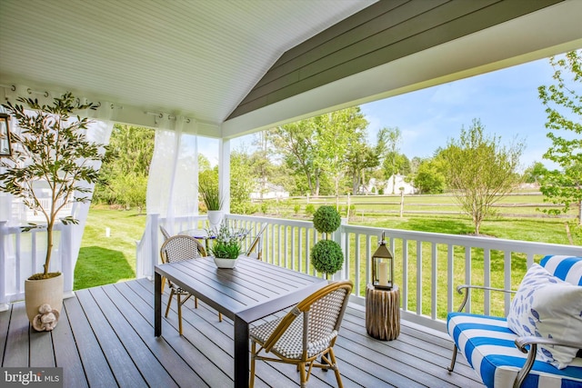 wooden terrace featuring a lawn