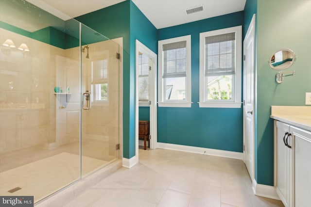 bathroom with vanity, walk in shower, and tile patterned flooring