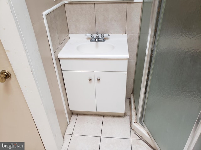 bathroom featuring an enclosed shower, vanity, and tile patterned flooring